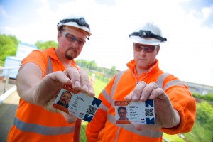 Workers holding Sentinel cards